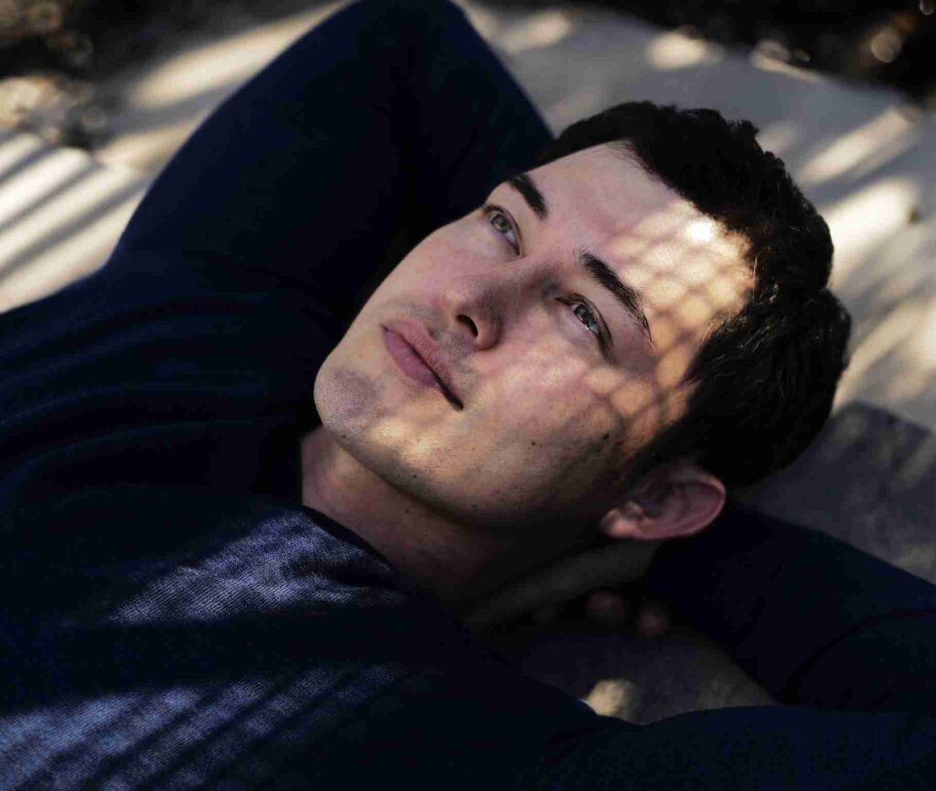 A man in a suit smiling on the cover of  David's Guide  magazine, titled  On The Brink of Greatness. 