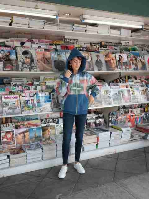 An elegant dining room with white tablecloths, red chairs, chandeliers, large windows, and ornate decor.