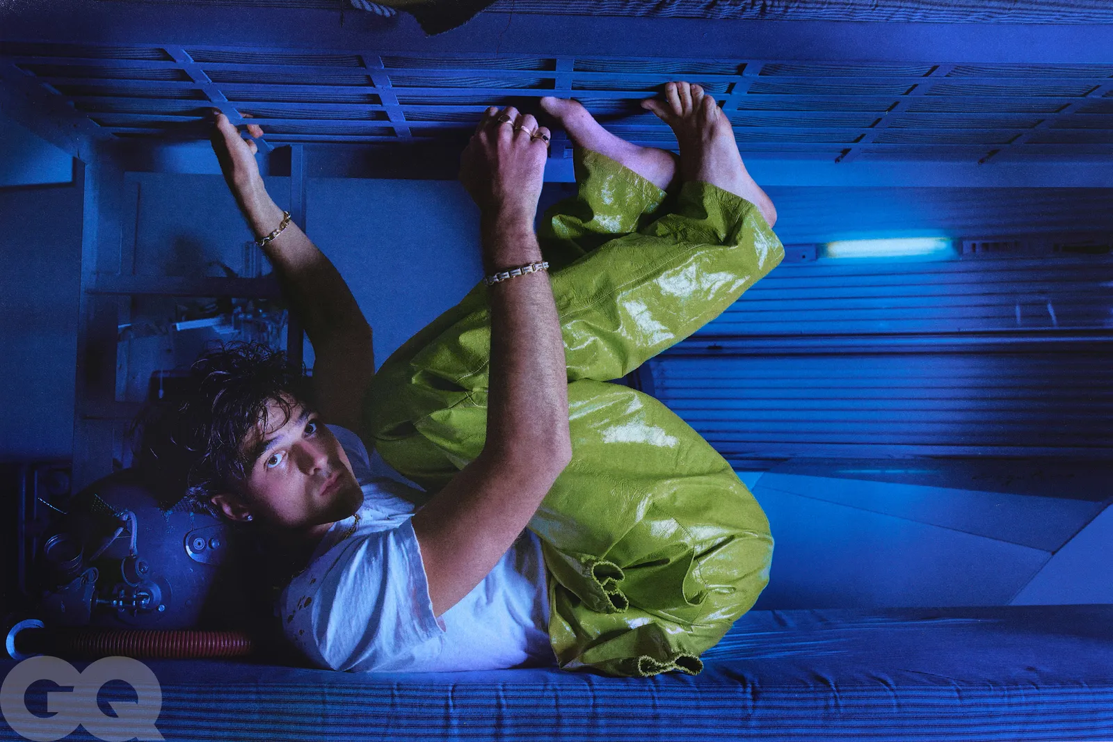 An elegant dining room with white tablecloths, red chairs, chandeliers, large windows, and ornate decor.