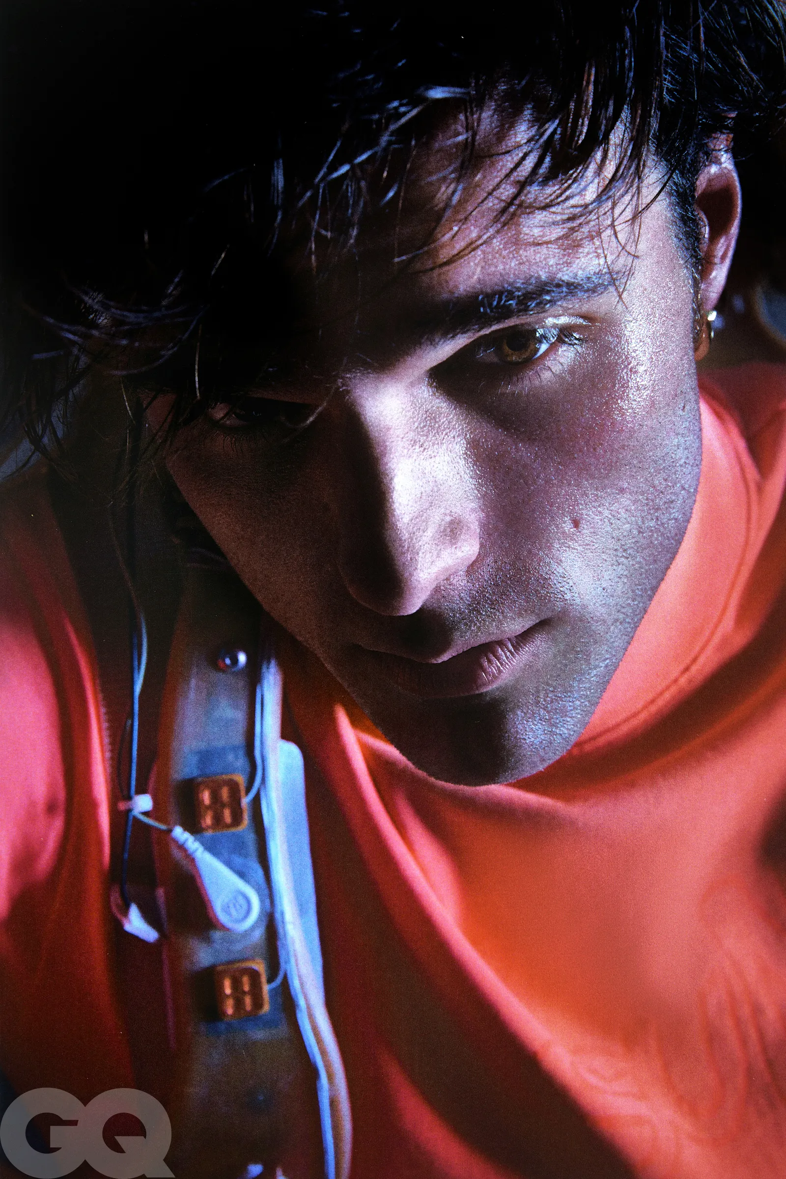 An elegant dining room with white tablecloths, red chairs, chandeliers, large windows, and ornate decor.