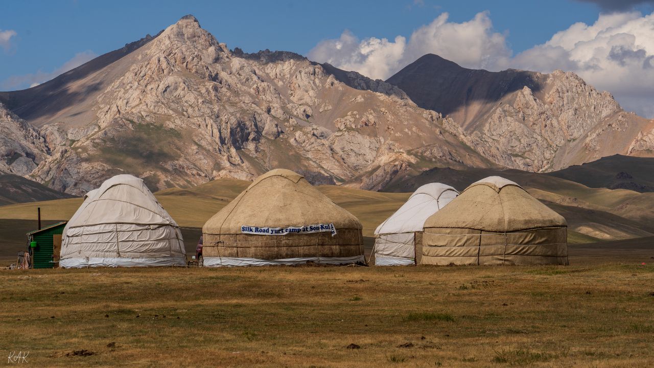 Panoramic view of Song-Kul Lake with yurts and grazing horses