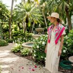 Guest strolling through lush hotel courtyard