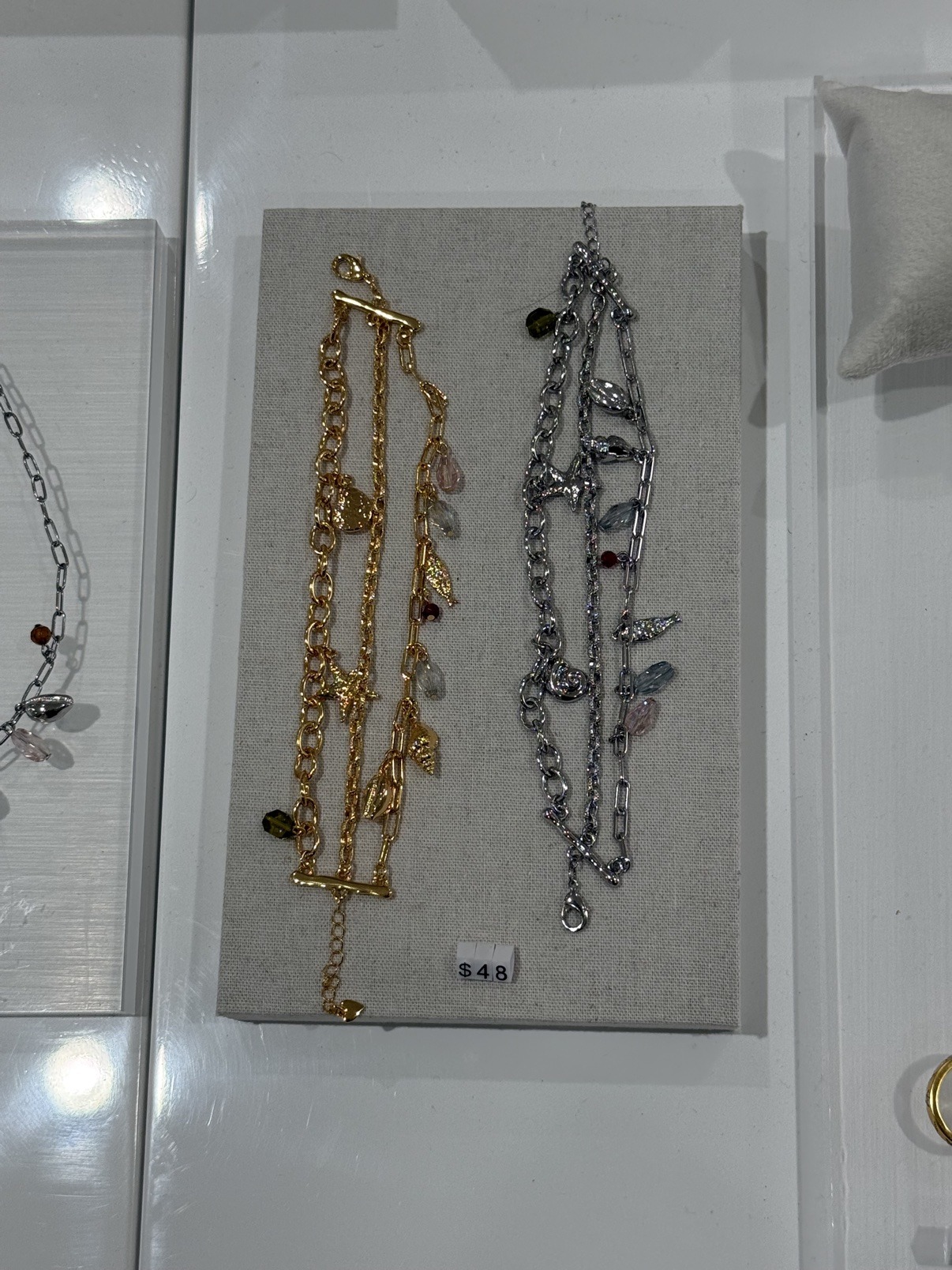 Gold and silver layered charm bracelets by en route, $48