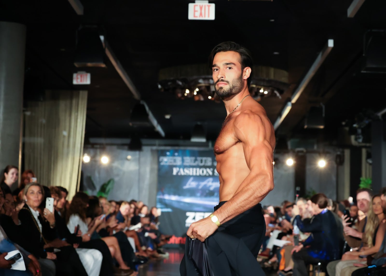 Sam Asghari walks the runway shirtless at the Blue Jacket Fashion Show