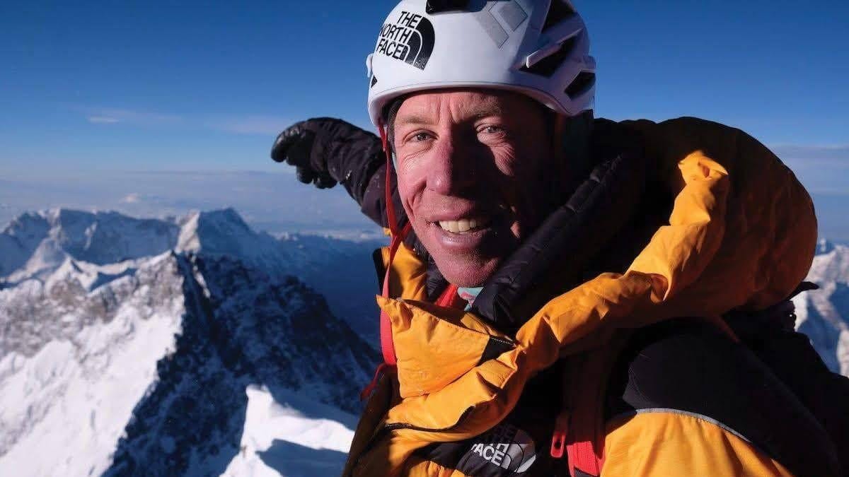 Mountaineer in North Face helmet taking selfie on Everest climb