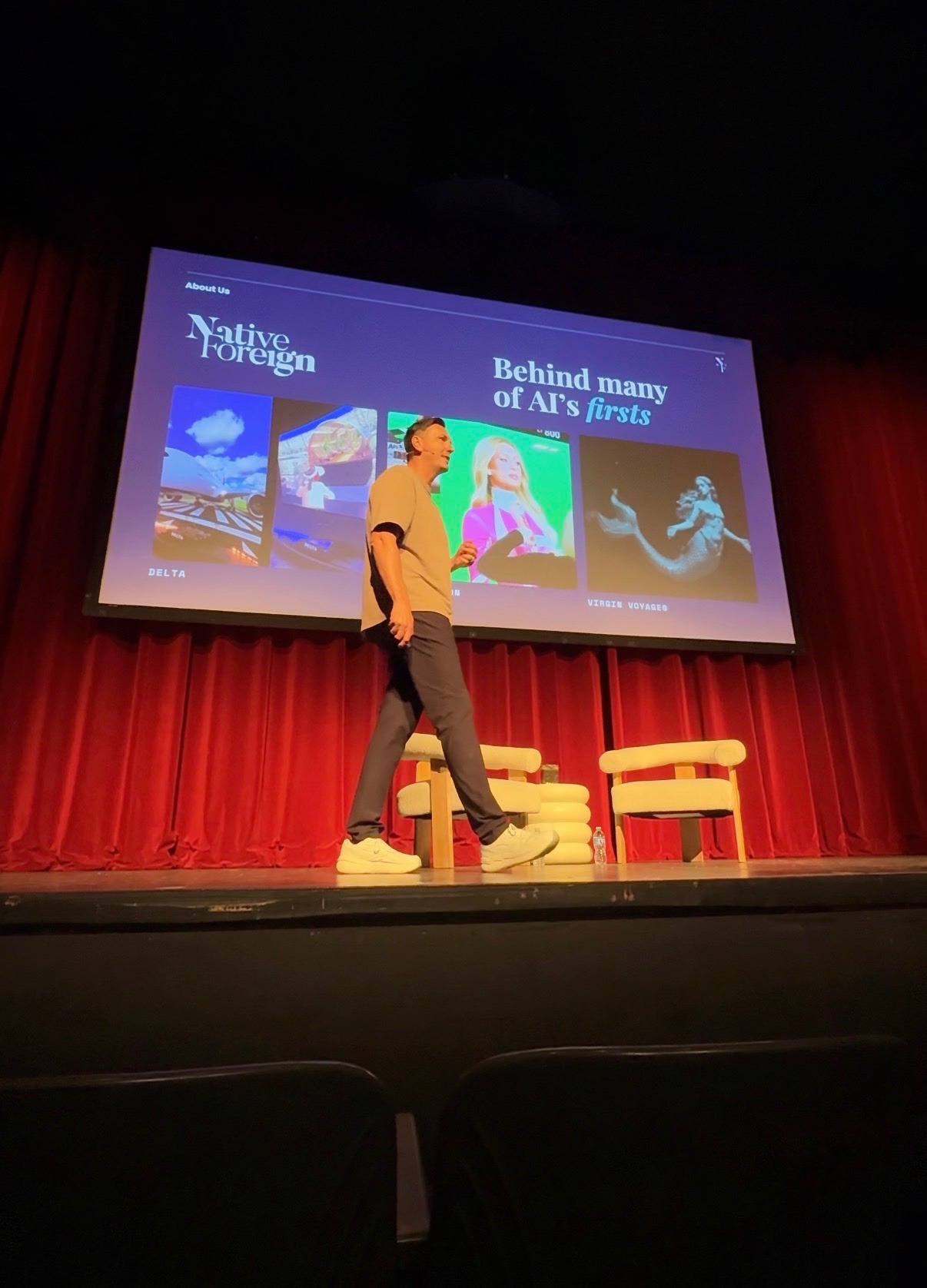 Speaker presenting Native Foreign’s "Behind many of AI’s firsts" reel, featuring AI work for Delta and Virgin Voyages, at AI Creator Day.