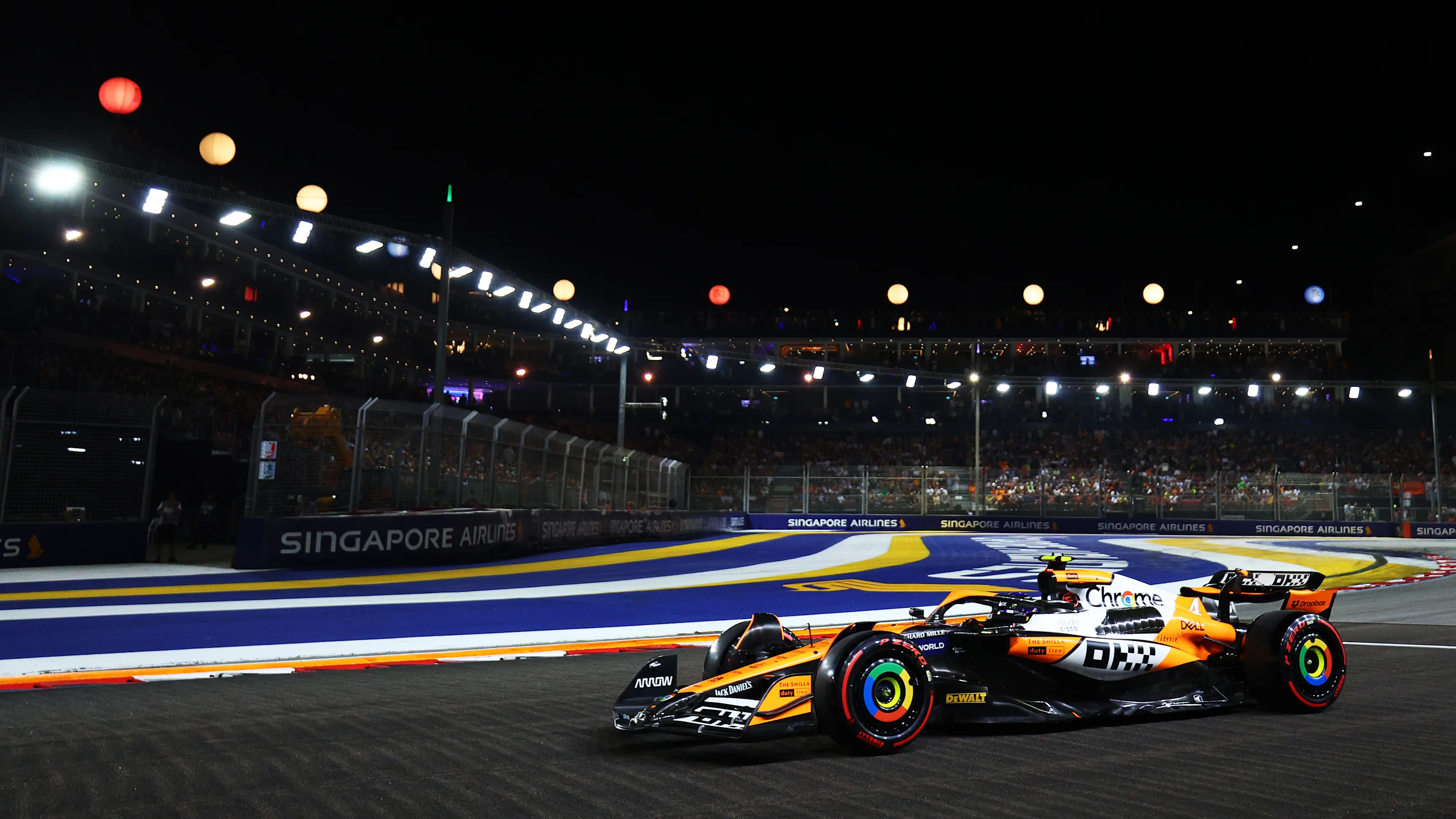 Qualifying action under floodlights at the 2024 Singapore Grand Prix.