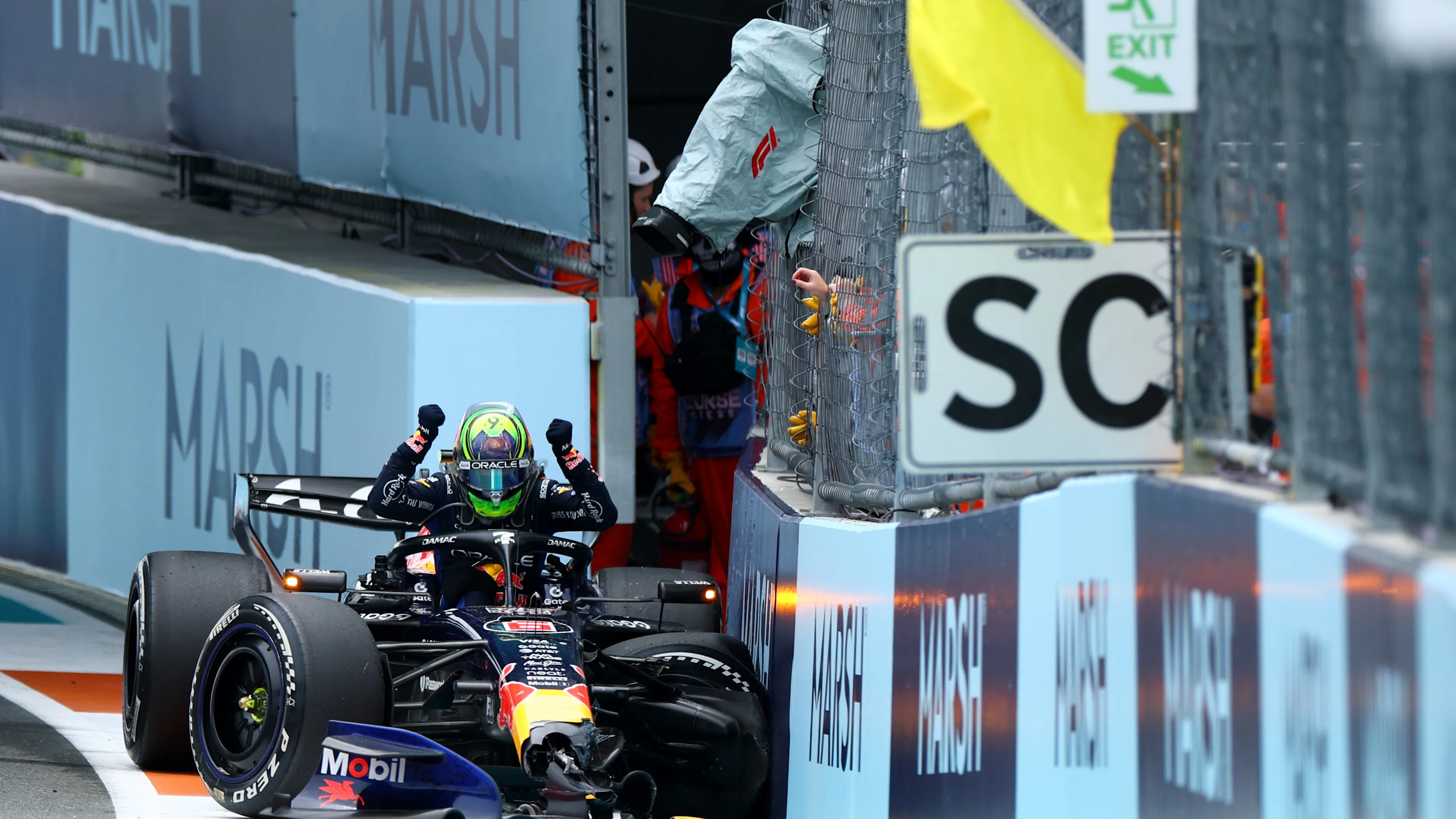 Isack Hadjar climbs out of his Oracle Red Bull Racing car after crashing at the Turn 14 chicane, bringing out the safety car.