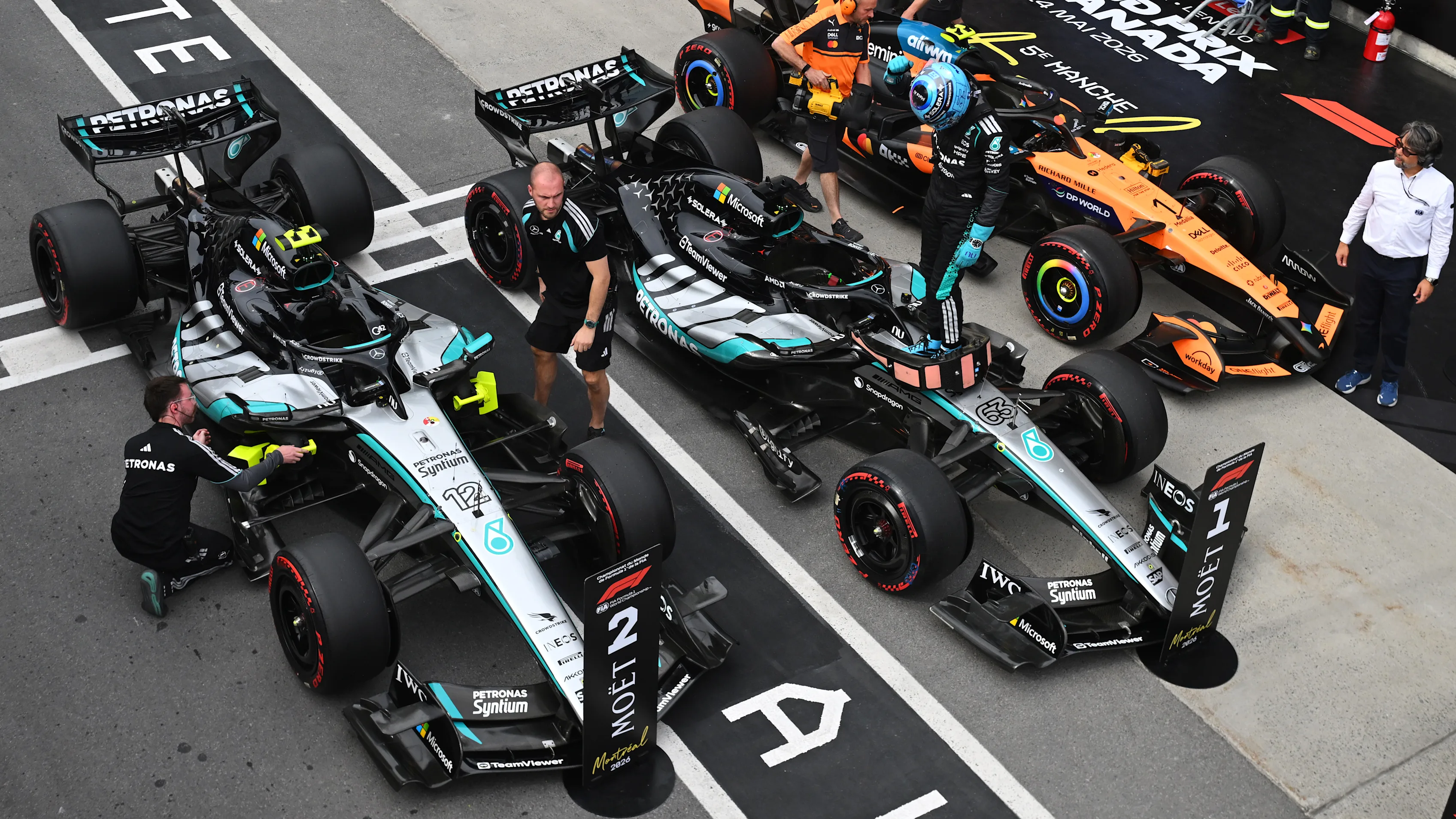 The sprint top three in parc fermé at Montreal, with sprint winner George Russell celebrating between Kimi Antonelli and Lando Norris at the first sprint weekend in Canadian Grand Prix history.