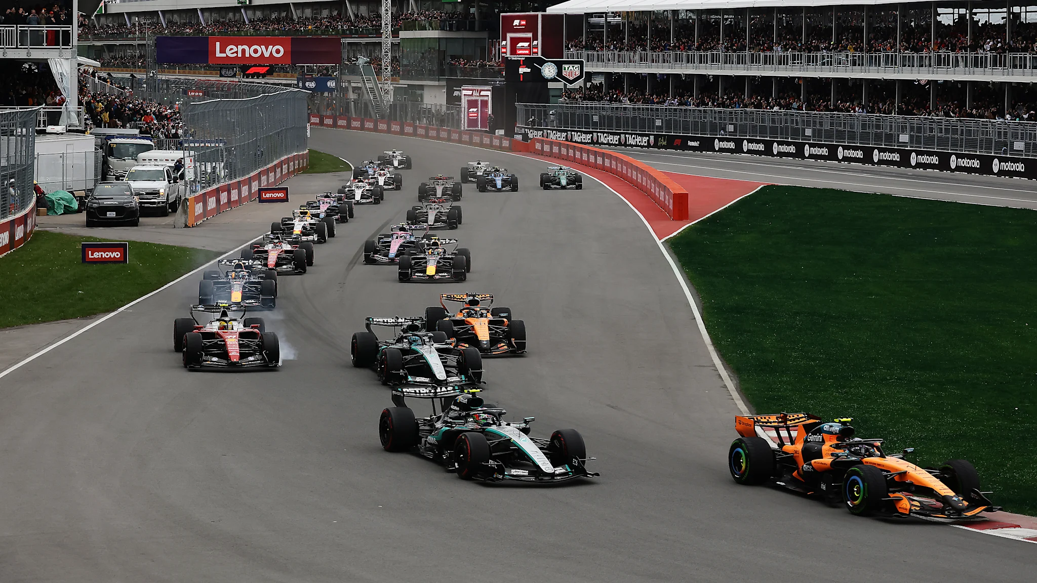 The field streams through the opening corners at the start of the Lenovo Canadian Grand Prix at the Circuit Gilles-Villeneuve in Montreal.