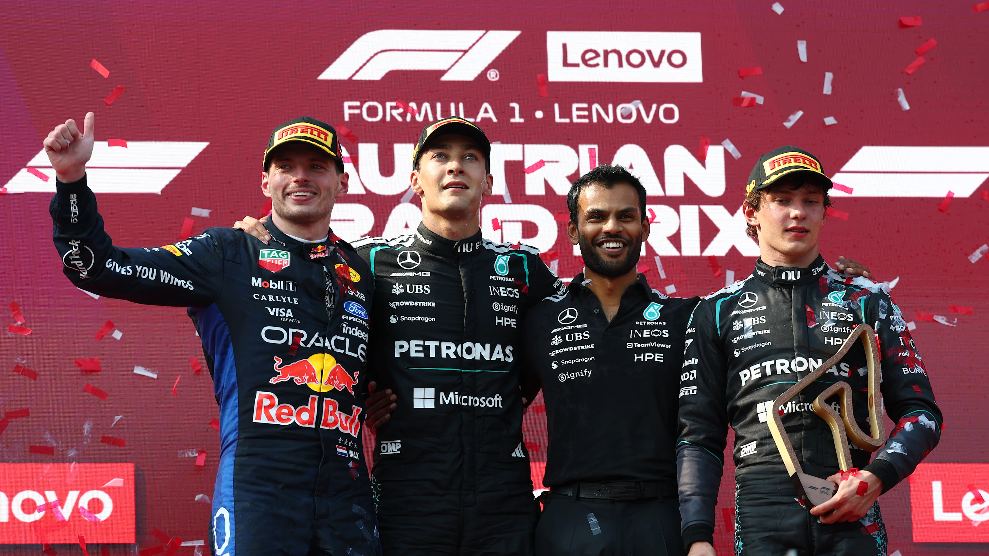 Race winner George Russell of Mercedes AMG Petronas celebrates on the podium at the 2026 Austrian Grand Prix