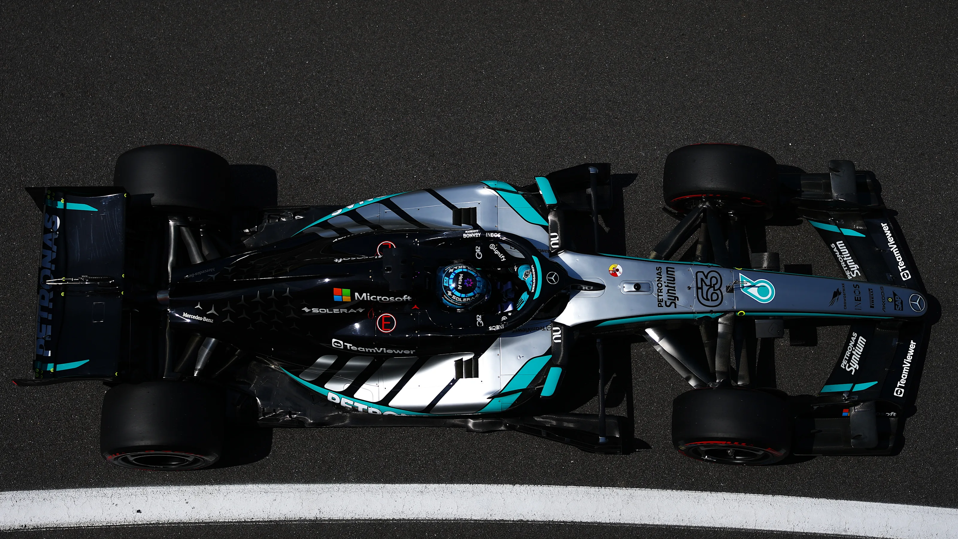 George Russell drives the No. 63 Mercedes through the pit lane at Silverstone during practice.