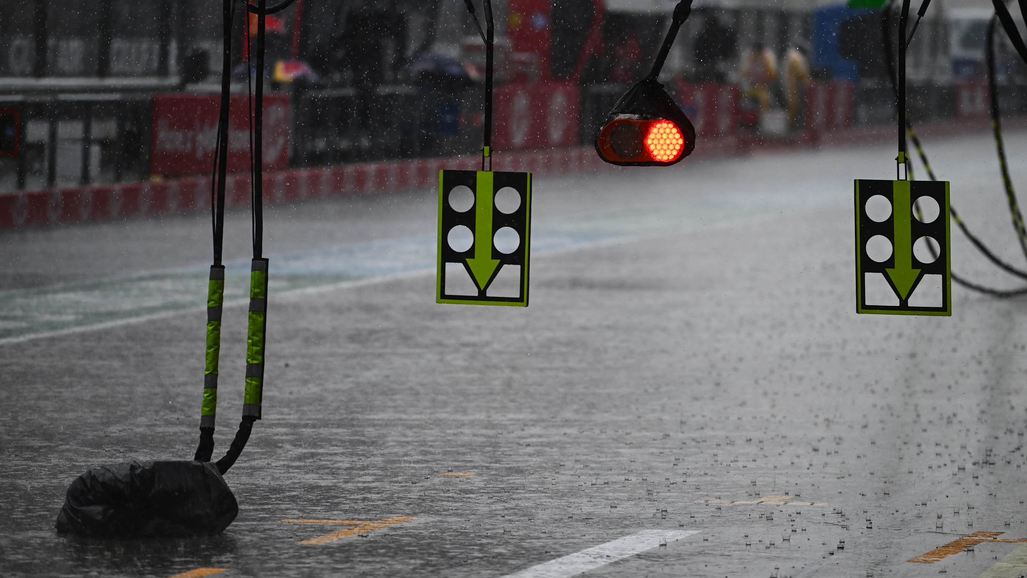 Rain falls over the pit lane at Sepang before the delayed start of the Bahrain Grand Prix in Malaysia.