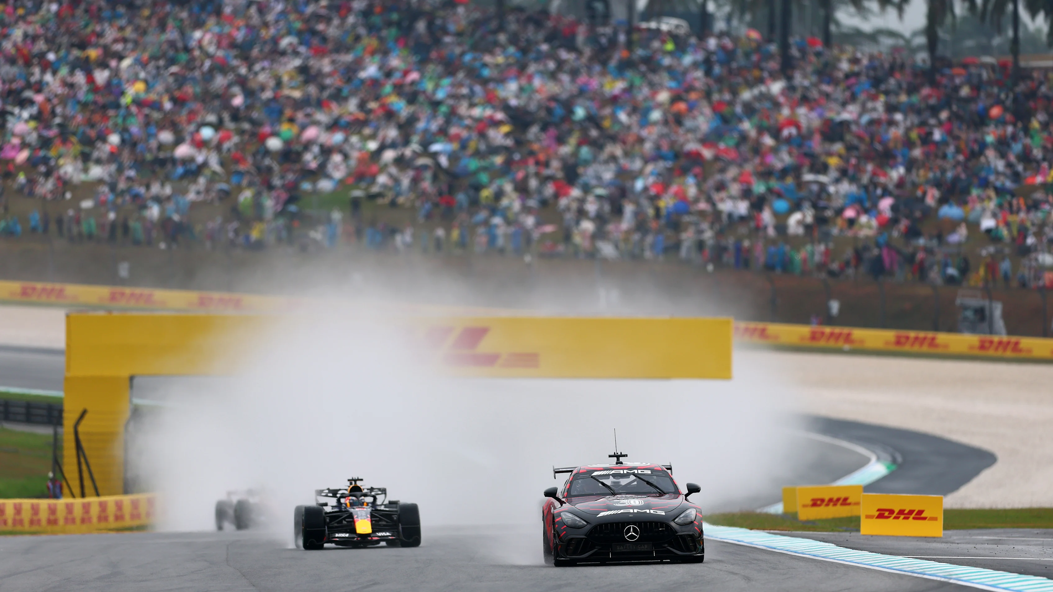 The FIA Safety Car leads Max Verstappen of Oracle Red Bull Racing on the wet formation lap at Sepang.