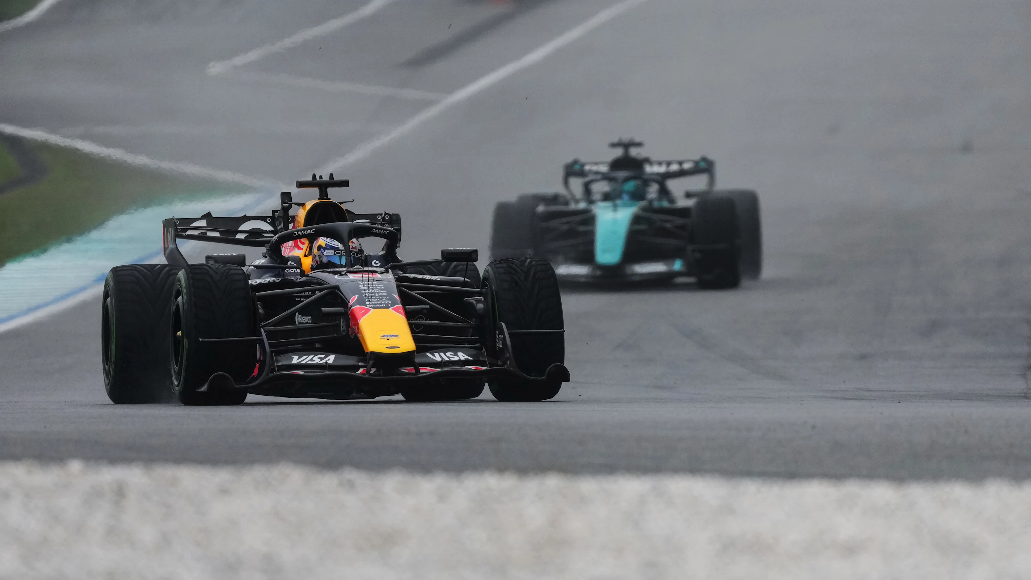 Max Verstappen drives the No. 3 Oracle Red Bull Racing car in wet conditions at the Sepang International Circuit.