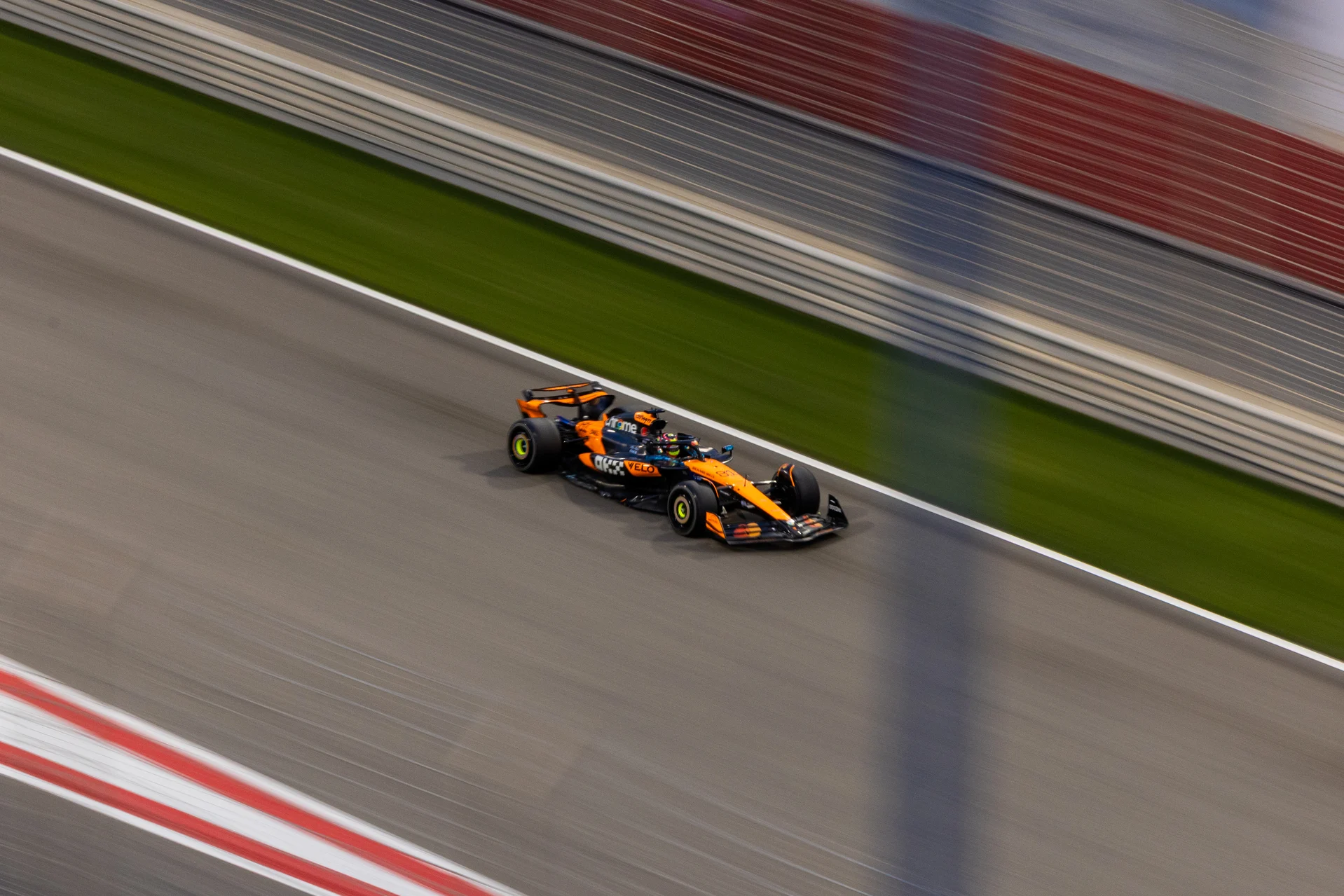 A McLaren Formula 1 car on track at night, from an official McLaren gallery image.