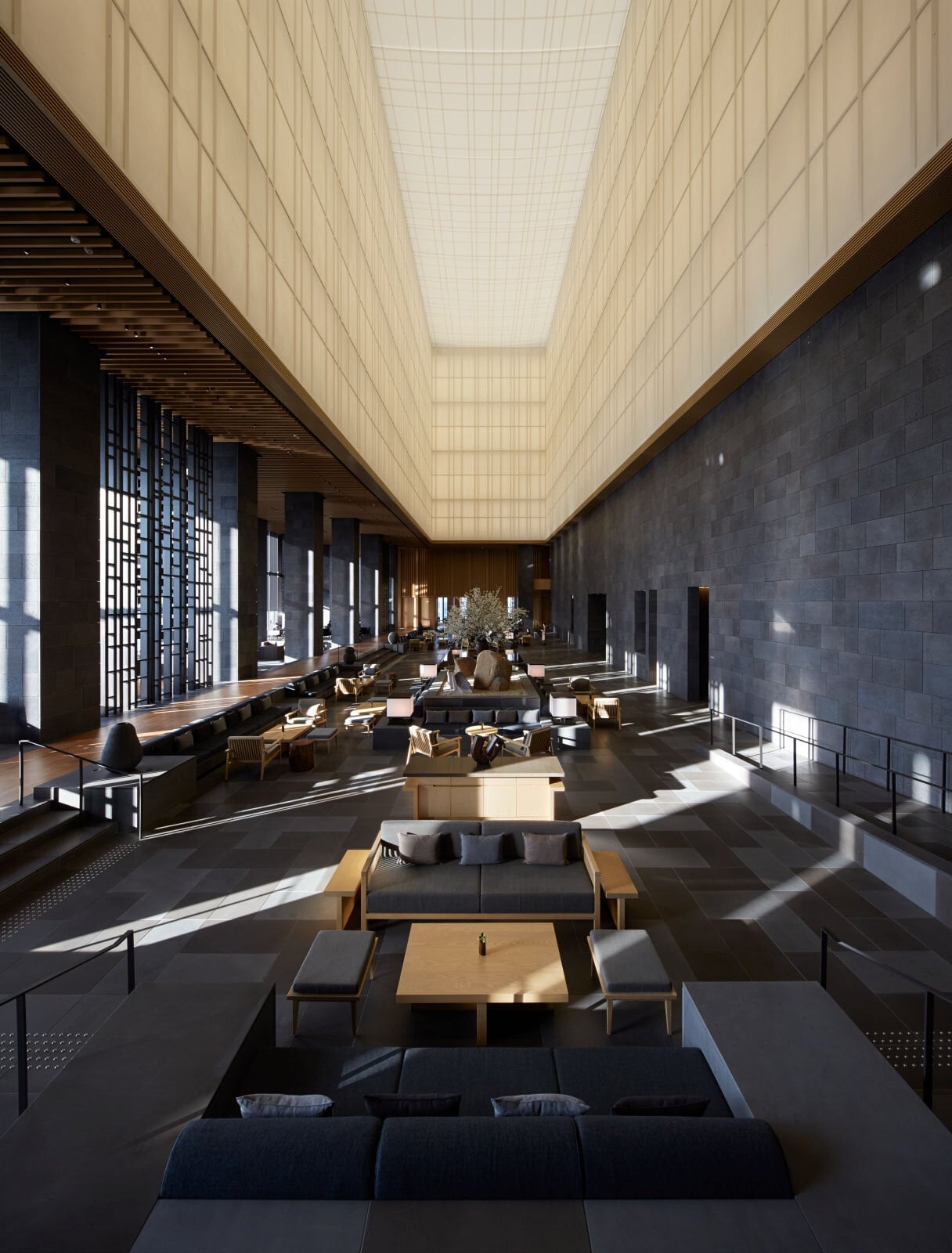 Aman Tokyo six-storey atrium lobby with washi paper lantern structure, inner garden and engawa veranda