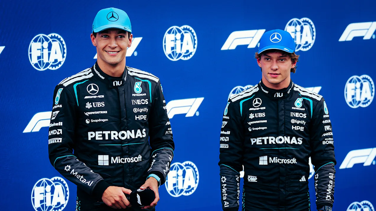 George Russell and Kimi Antonelli in their Mercedes race suits at an FIA event.