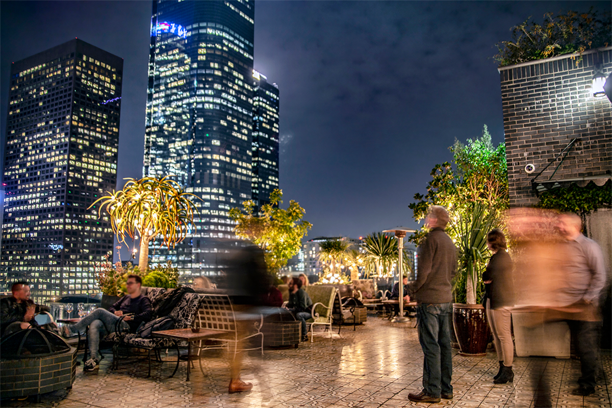 Perch rooftop lounge terrace with downtown Los Angeles skyline at dusk