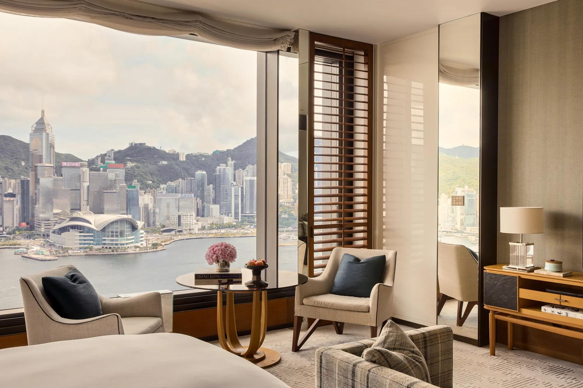 Grand Harbour View Room at Rosewood Hong Kong, a king room with a freestanding soaking tub, marble bathroom and a Victoria Harbour view