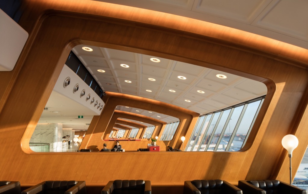 Elegant airport lounge interior with comfortable armchairs and large windows
