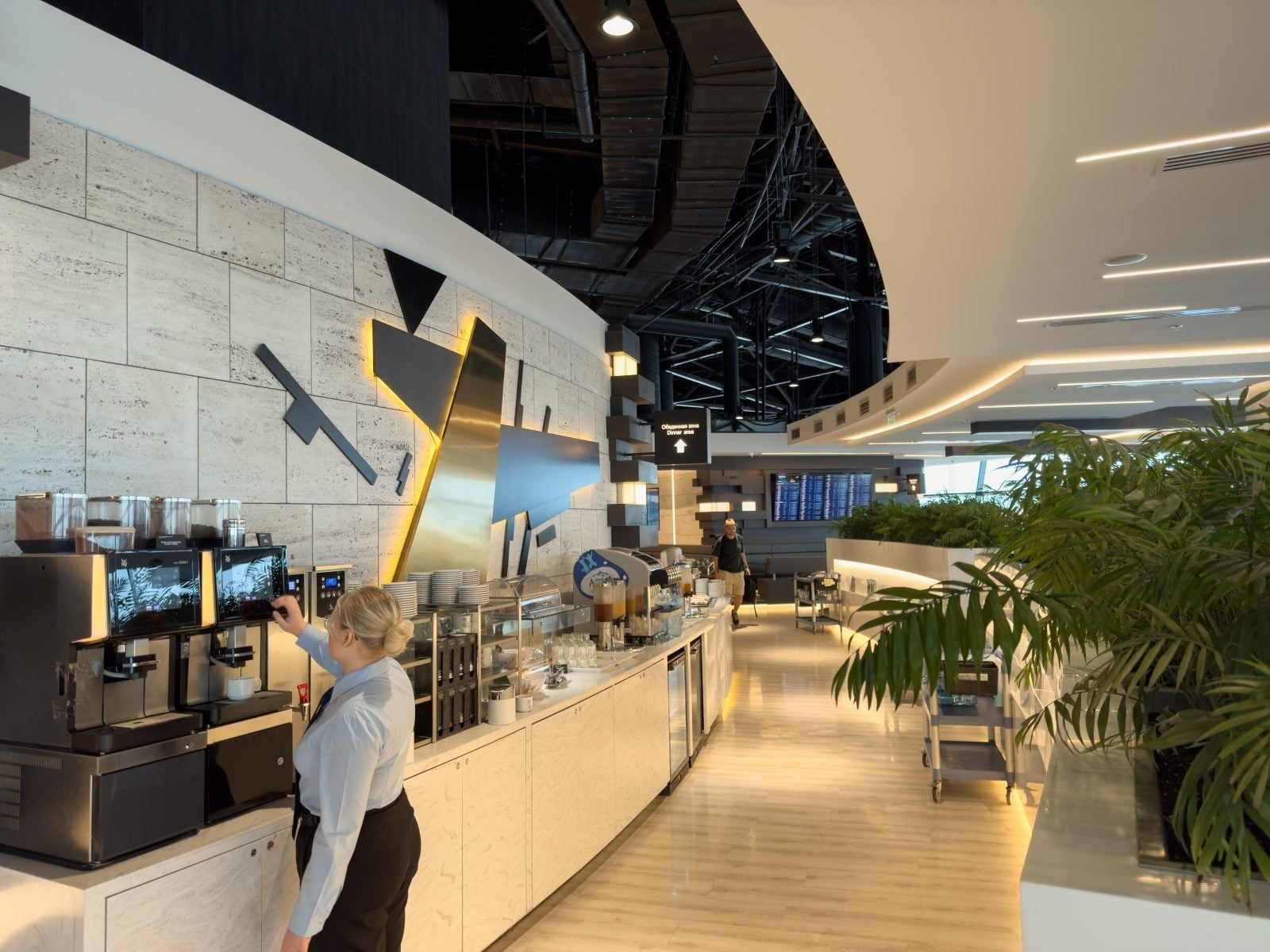 Traveler relaxing in a premium airport lounge with a coffee