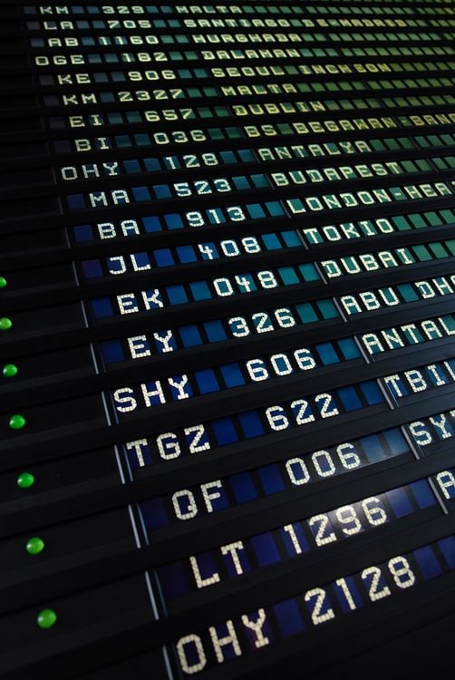 Airport departures board showing flight destinations