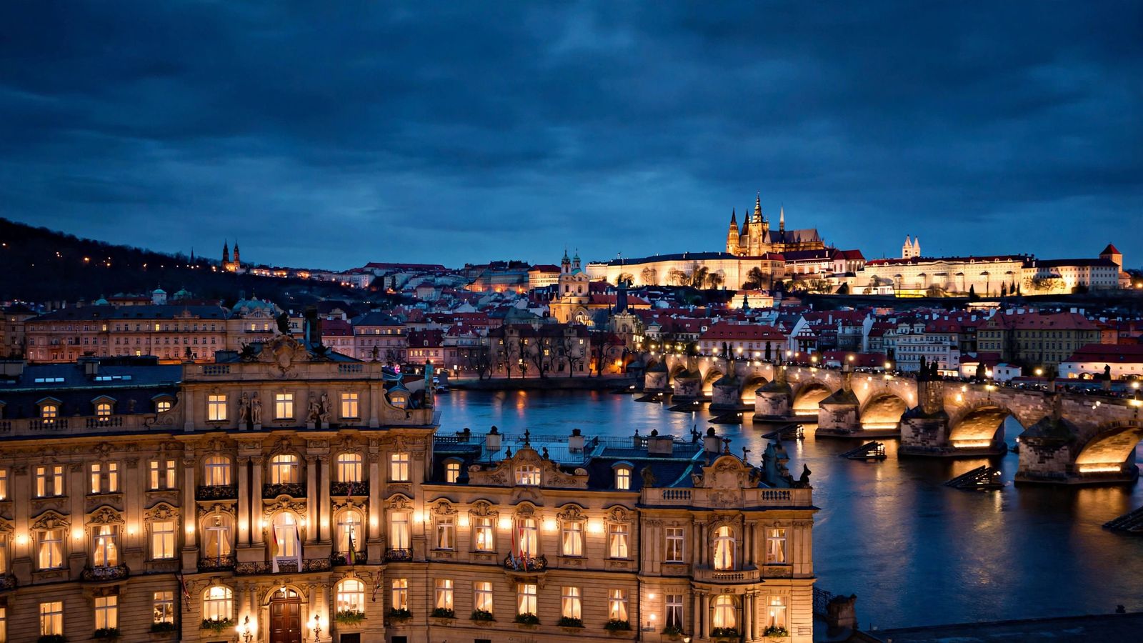 Prague's Charles Bridge and castle glowing at dusk, home to the best luxury hotels in Prague