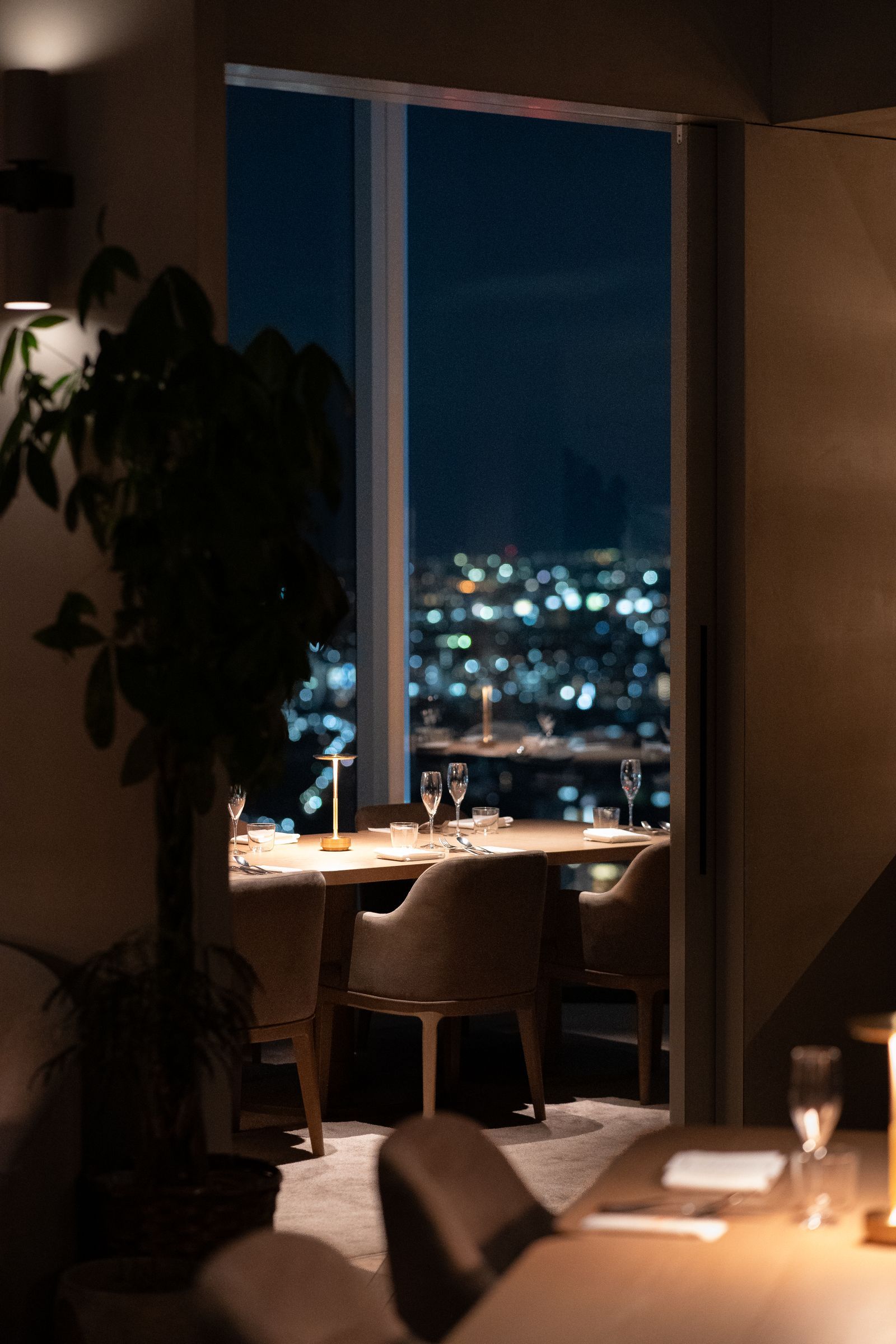Elegant restaurant dining room in Tokyo with glittering night city views, dining at the best luxury hotels in Tokyo