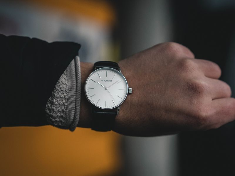 Minimalist luxury wristwatch with a black leather strap worn on a wrist, showing how the best luxury watches look in 2026
