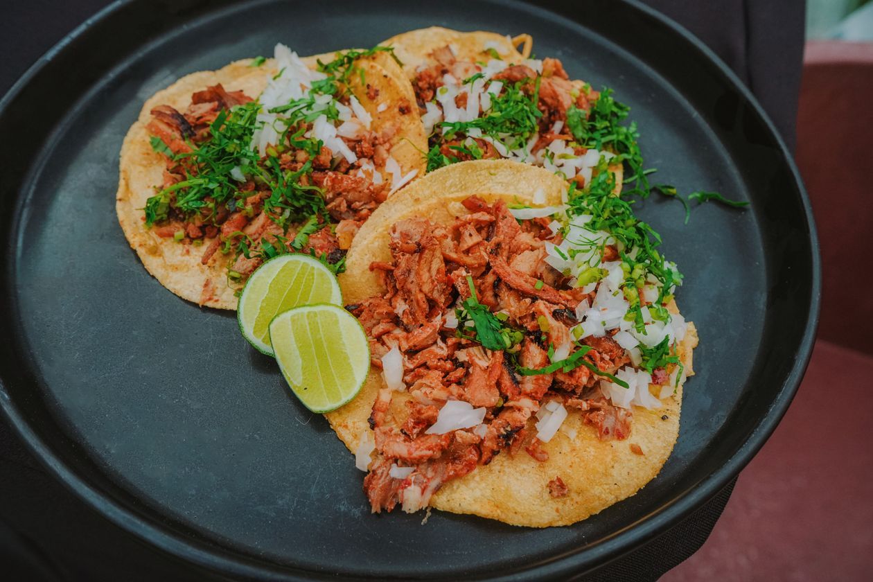Street tacos al pastor with onion, cilantro, and lime, among the best tacos in Los Angeles