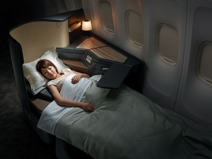 Lie-flat business class seat in a modern wide-body airplane cabin