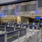 Row of CLEAR biometric kiosks at an airport security checkpoint
