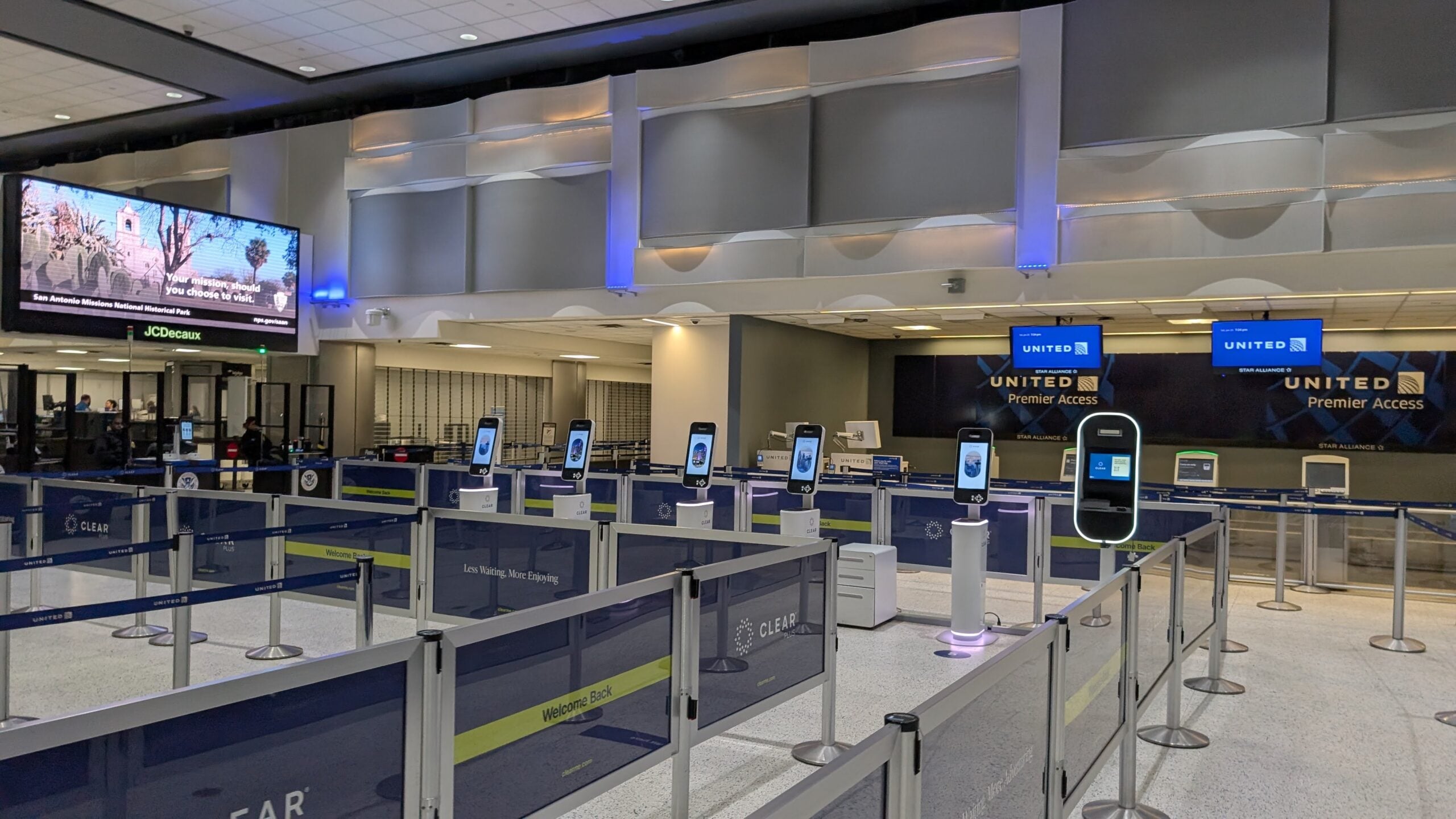 Row of CLEAR biometric kiosks at an airport security checkpoint