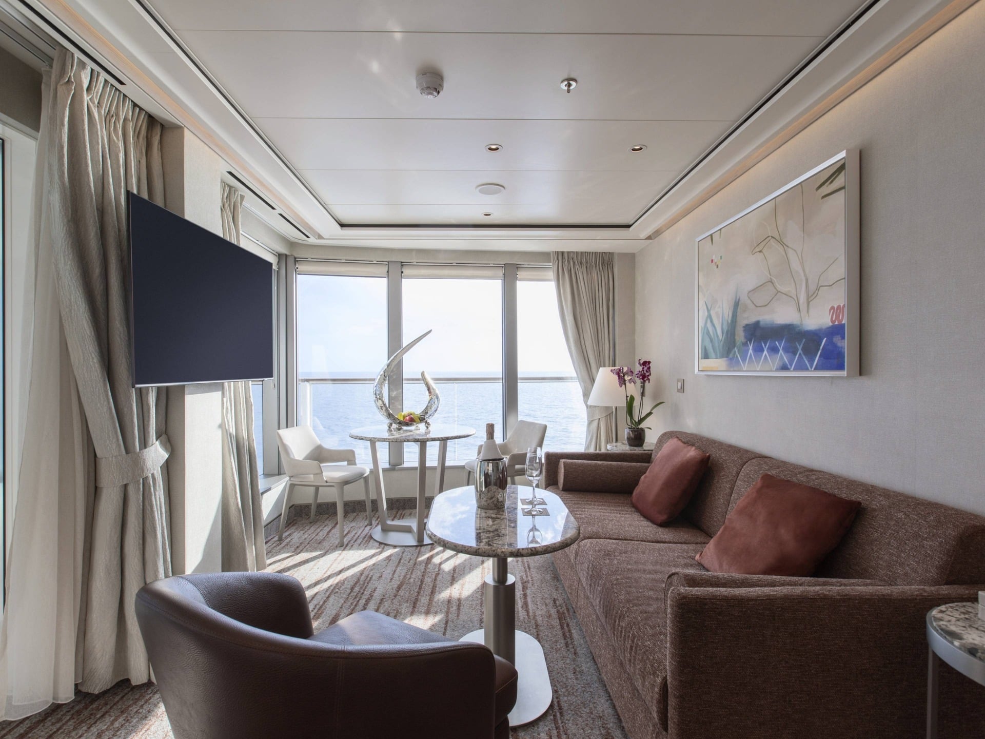 Luxury cruise ship suite with panoramic windows overlooking the ocean