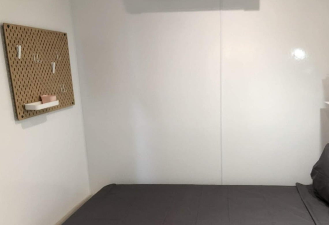 Interior of a Connect modular unit bedroom with built-in storage and warm finishes