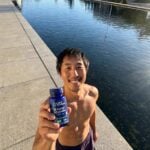 David holding Life Extension NAC bottle in front of the water.