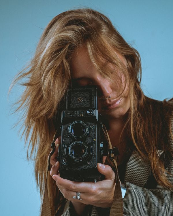 Vintage film camera on a tripod, photographer at work