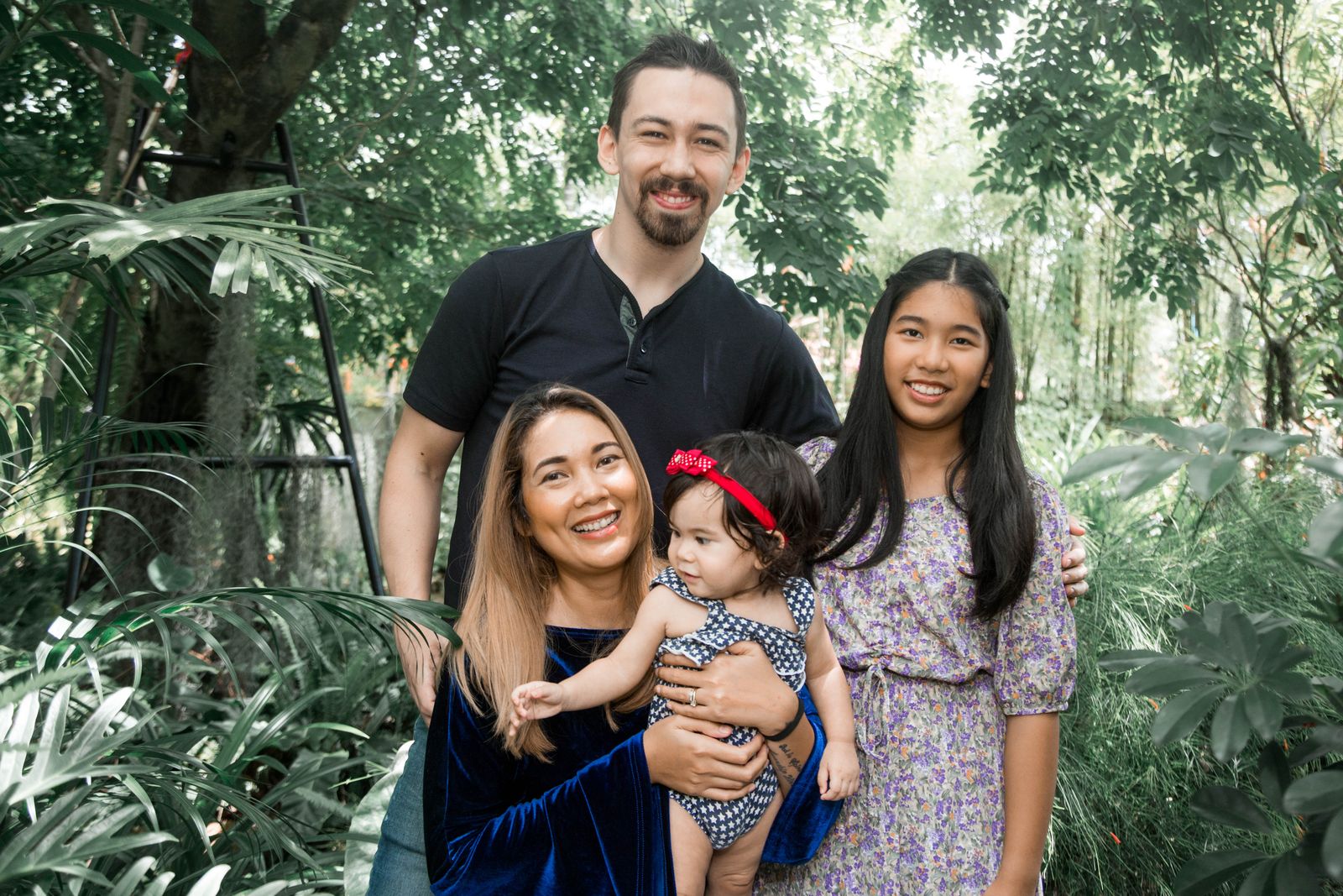 Cheerful family outdoors in lush greenery for Los Angeles holiday portraits