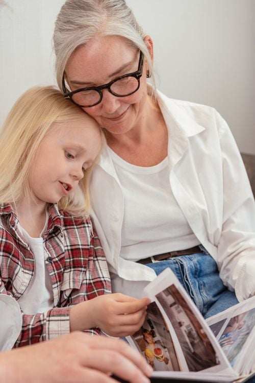 Mother and daughter looking through a photo album of family memories