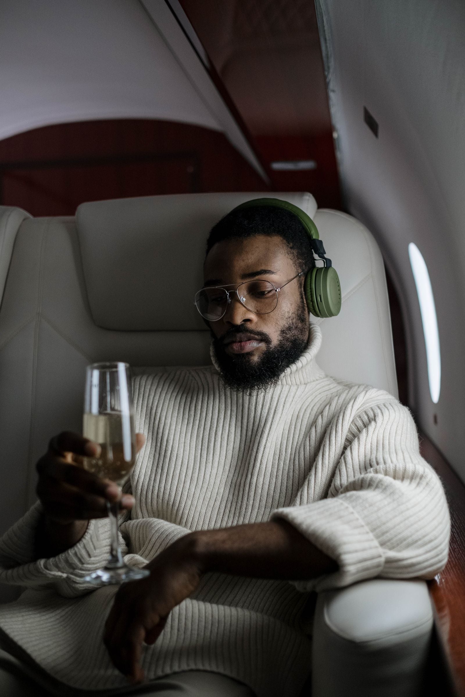 Passenger relaxing with champagne in a luxury first class cabin