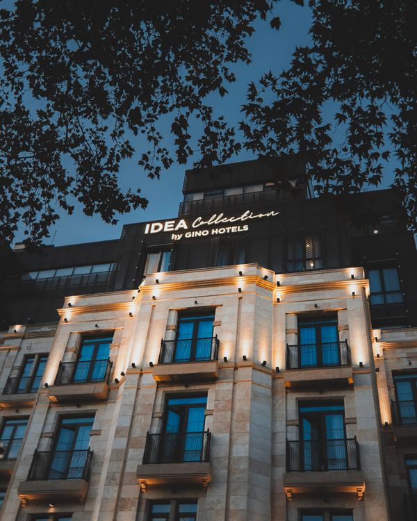 Elegant luxury hotel facade glowing in warm evening lighting