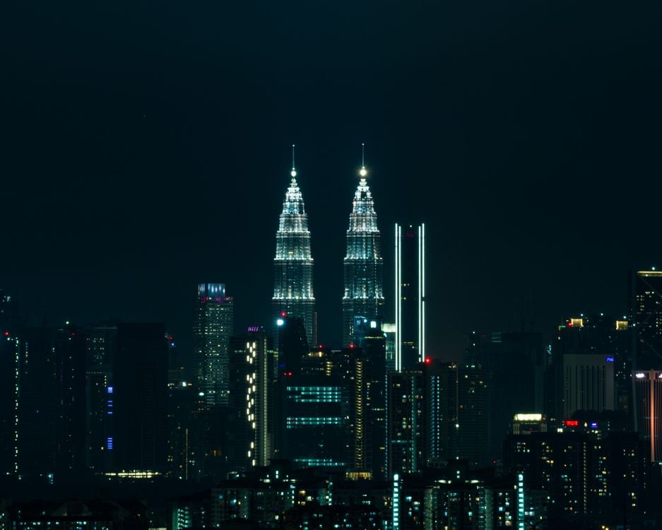 Kuala Lumpur skyline at night with the illuminated Petronas Towers above the city lights