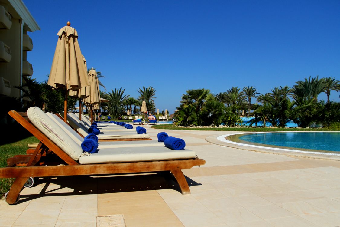 Luxury poolside loungers at a tropical resort hotel