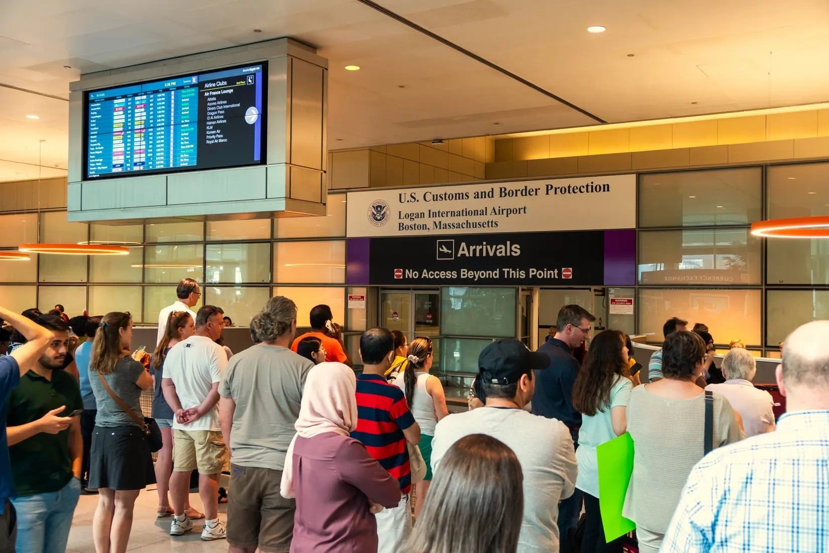 Long line of travelers waiting at the U.S. Customs and Border Protection arrivals hall at Boston Logan International Airport