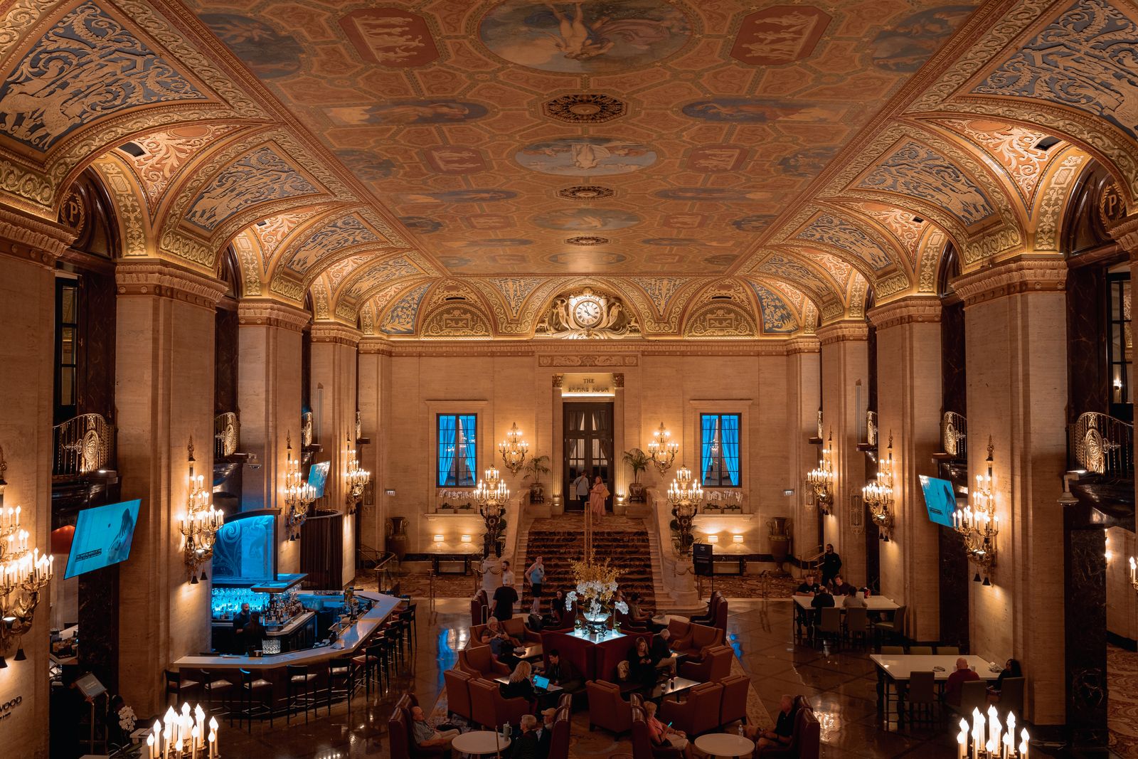 Grand luxury hotel lobby with ornate ceiling and chandeliers