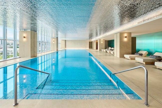 Indoor swimming pool with lounge chairs at a luxury hotel