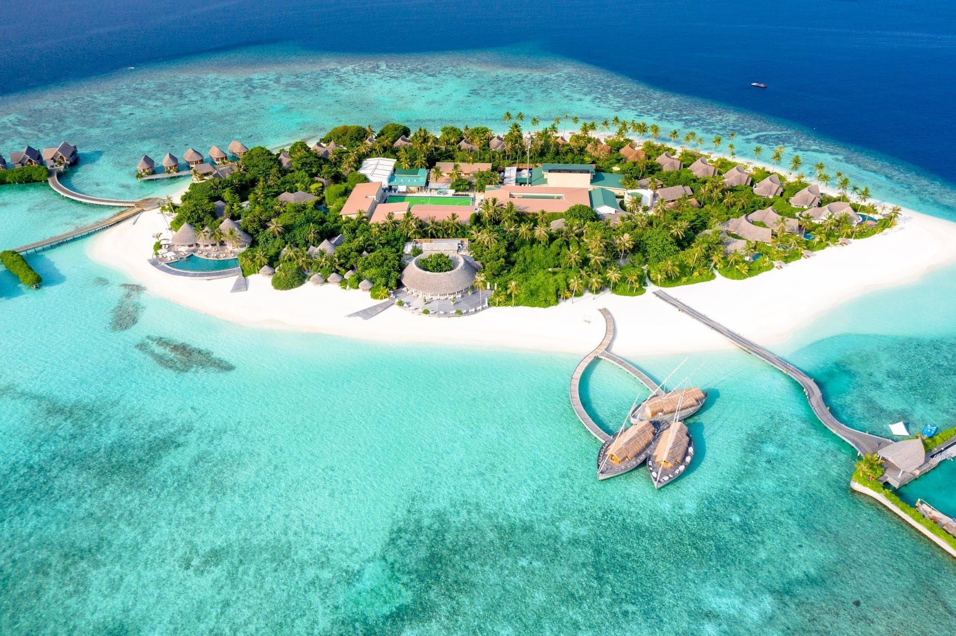 Sunset over an infinity pool at a Maldives luxury resort