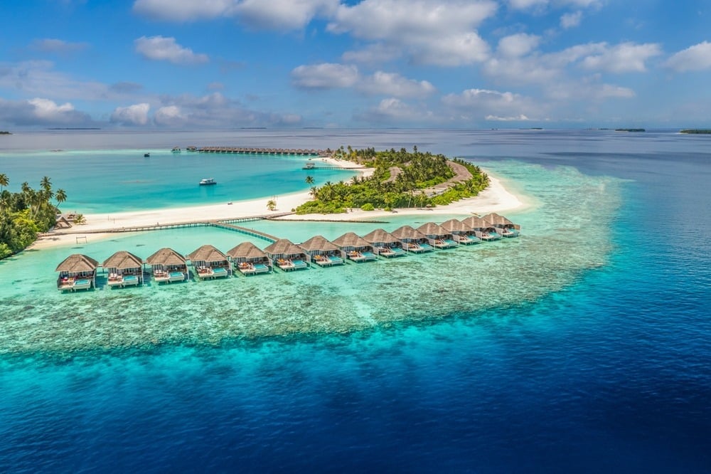 Aerial view of Maldives overwater villas above turquoise lagoon water