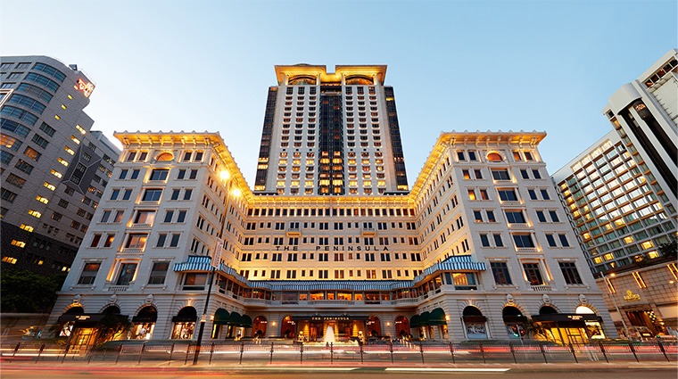 The Peninsula Hong Kong forecourt on Salisbury Road, Tsim Sha Tsui, with the Peninsula green Rolls-Royce fleet in front of the hotel facade